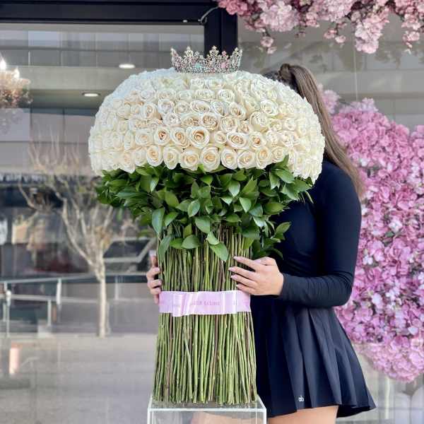 Large dome bouquet of white roses with a jeweled crown on top