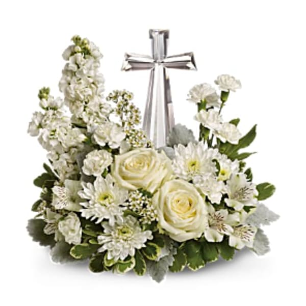 White floral arrangement with a silver cross centerpiece