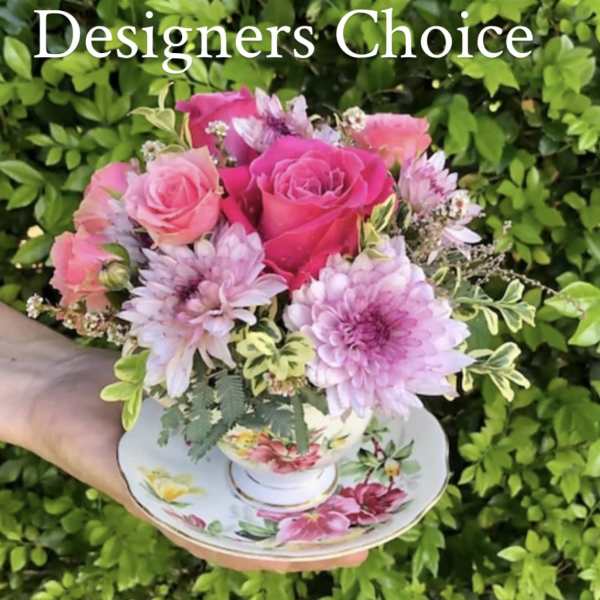 Pink rose and lavender chrysanthemum bouquet in a floral teacup