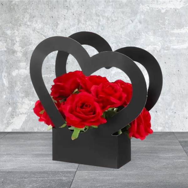 Red roses arranged in a black heart-shaped box