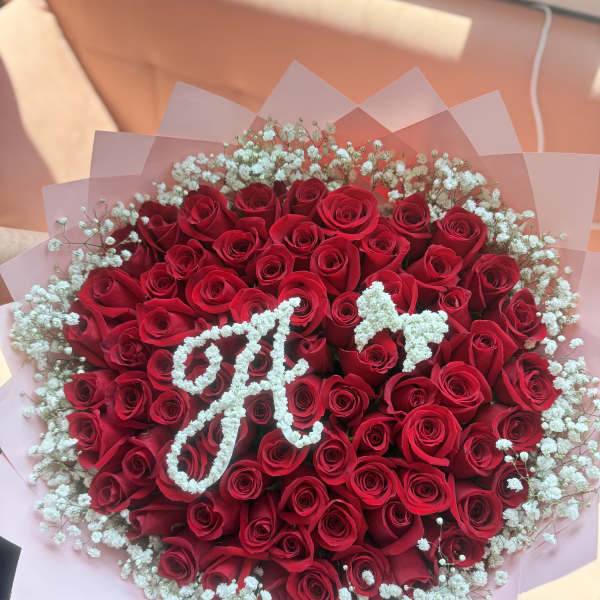 Bouquet of red roses with white baby's breath in pink wrap