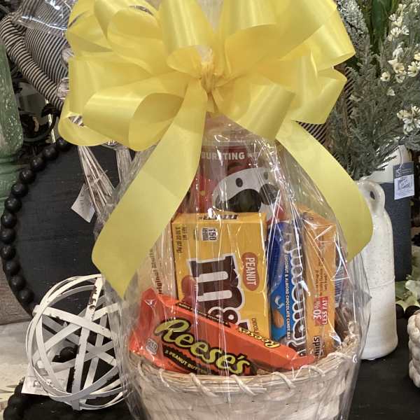 Gift basket with candy bars wrapped in clear cellophane and a yellow bow