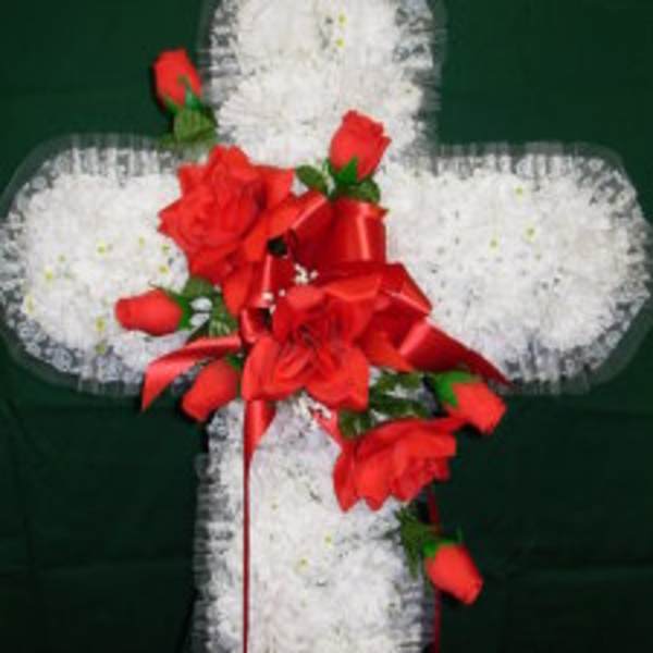 White floral cross with red roses and ribbon