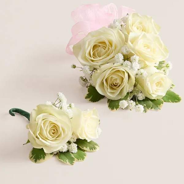 White rose bouquet and matching boutonniere with pink ribbon
