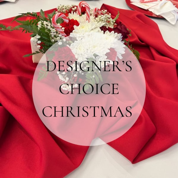 Christmas bouquet with red and white flowers on red fabric