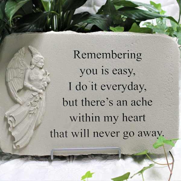 Memorial stone plaque with an angel relief and engraved text