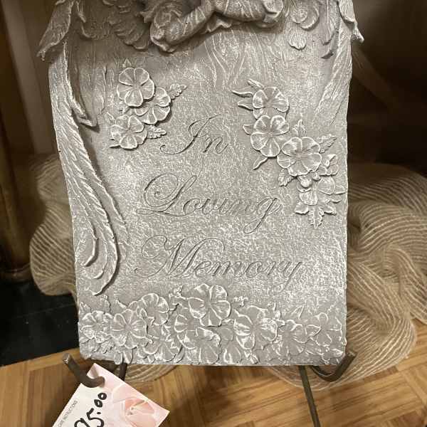 Silver memorial plaque with angel and floral relief reading "In Loving Memory"