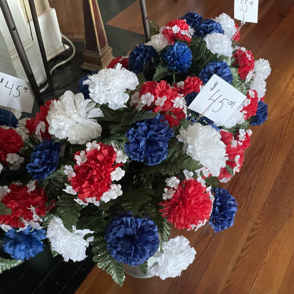 Red, white, and blue carnation arrangement in a vase