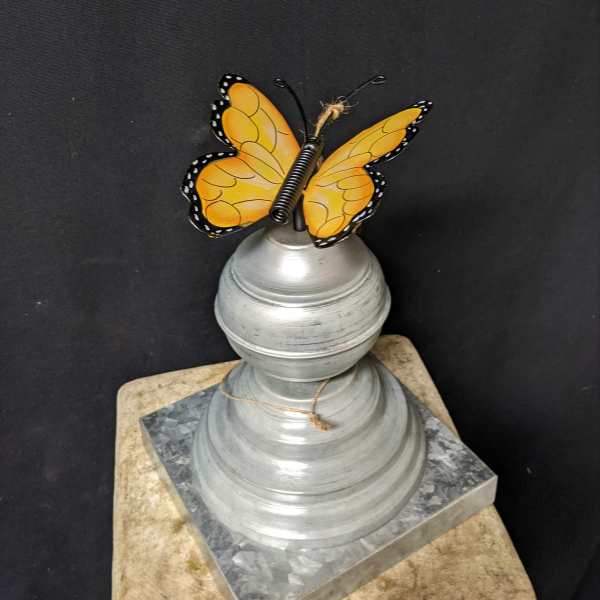 Butterfly ornament on a silver decorative pedestal