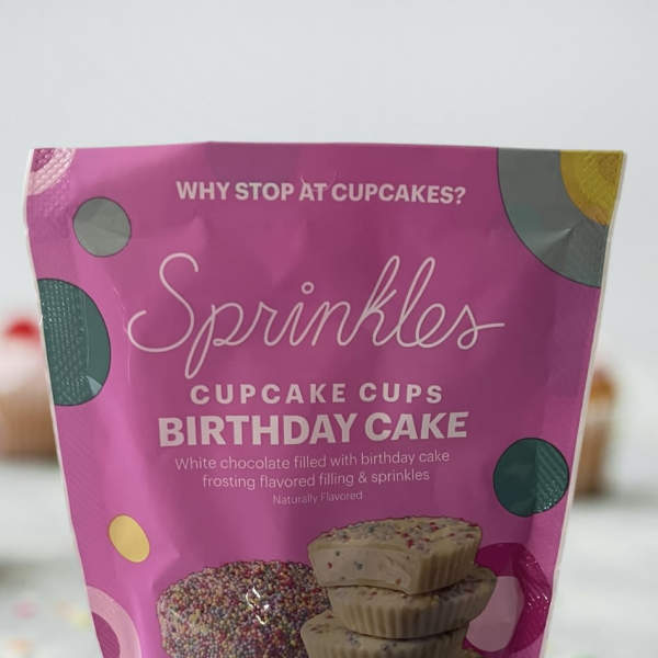 Pink bag of birthday cake cupcake cups with sprinkled candy pieces