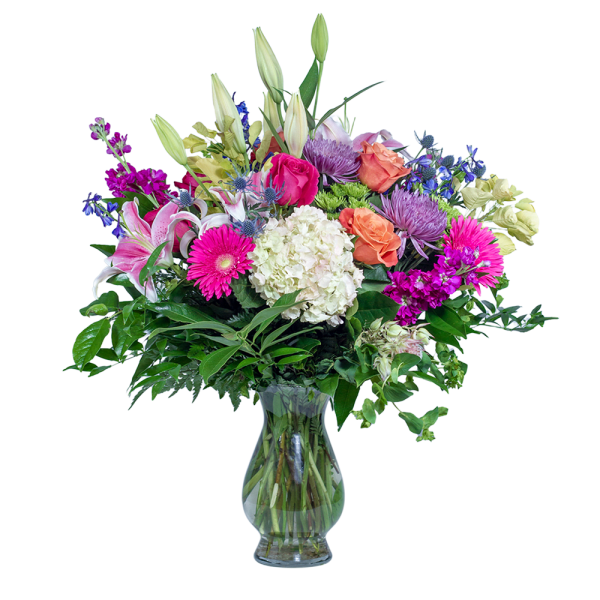 Mixed bouquet of lilies, roses, and daisies in a glass vase