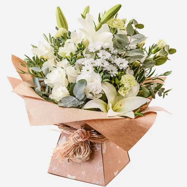 White floral bouquet in brown paper wrap with a decorative box base