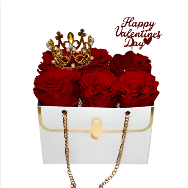 Red roses in a white gift box with a crown and Valentine topper