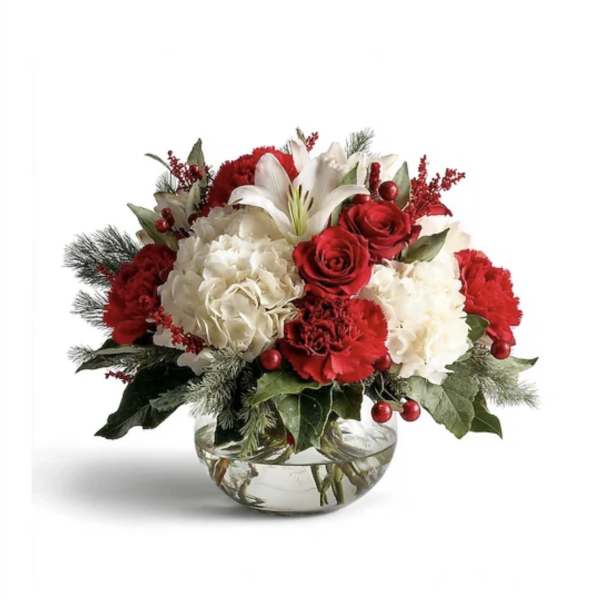 Red and white floral arrangement in a clear glass bowl vase