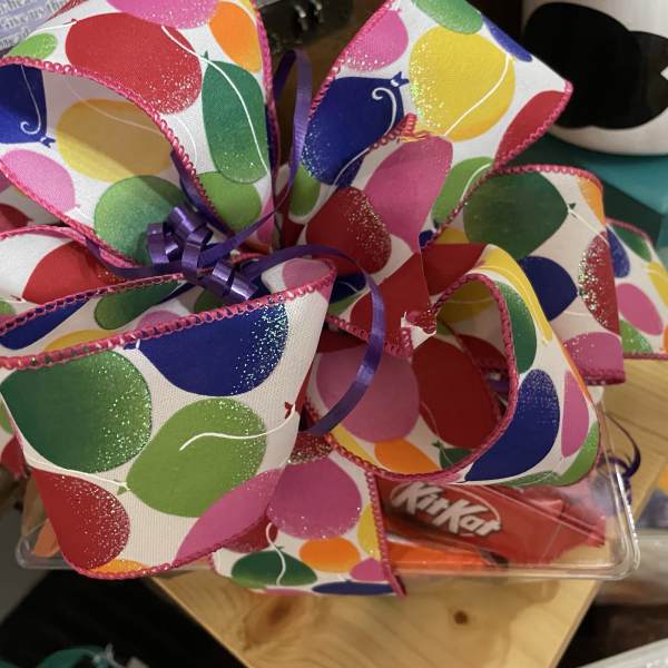 Gift tray with colorful ribbon bow and candy bars