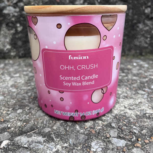 Pink scented candle in a metal tin with a wooden lid
