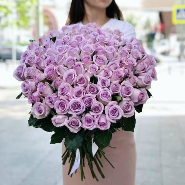 Large bouquet of lavender roses held by a person