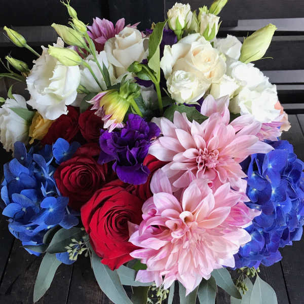 Bouquet of red and white roses with pink dahlias and blue hydrangeas