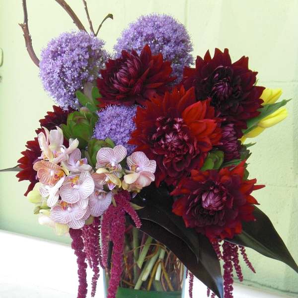Mixed bouquet in a clear glass vase with purple, red, and white flowers