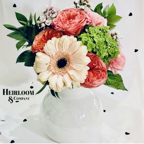 Bouquet of pink and cream flowers in a clear glass vase