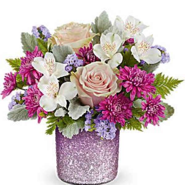 Pink and white flowers arranged in a glittery purple vase