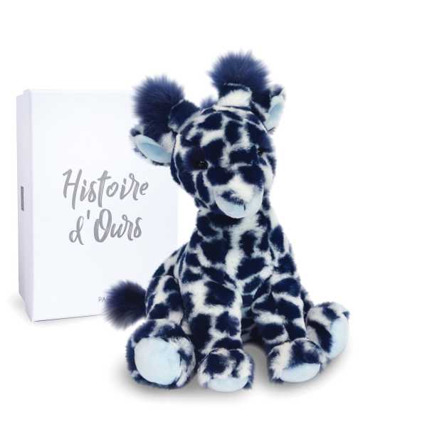 Plush giraffe toy beside a white gift box