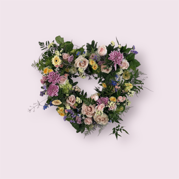 Heart-shaped floral wreath with pastel roses and chrysanthemums