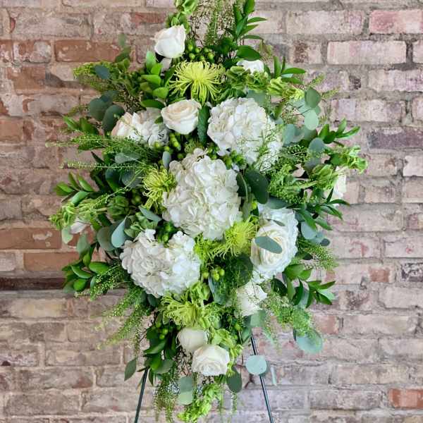 Tall white and green floral standing spray on an easel