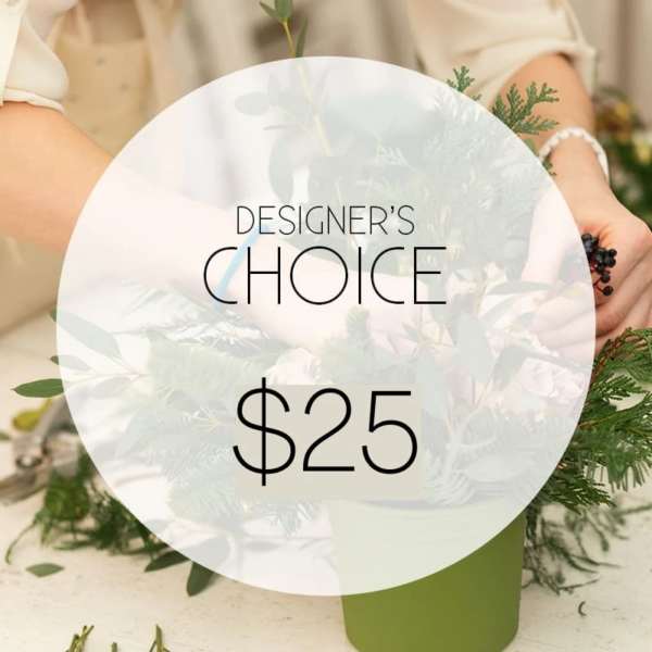 Green floral arrangement in a green container with a designer's choice sign