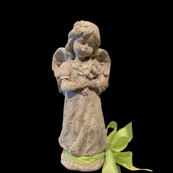 Stone angel figurine with a green ribbon bow