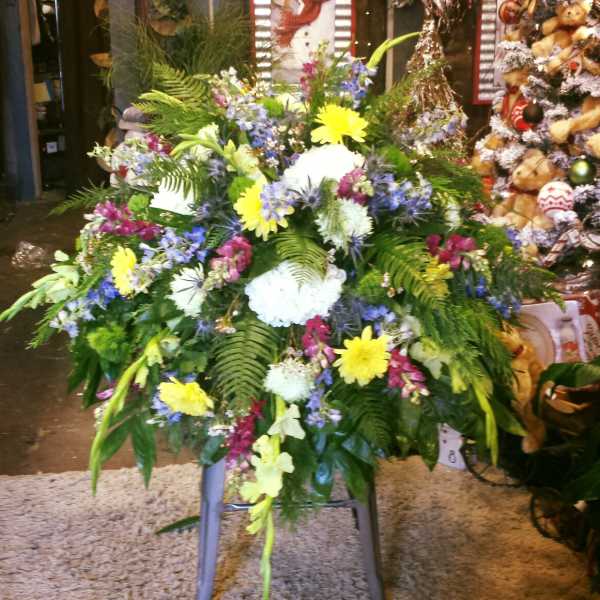 Large mixed floral spray with yellow, white, blue, and pink blooms
