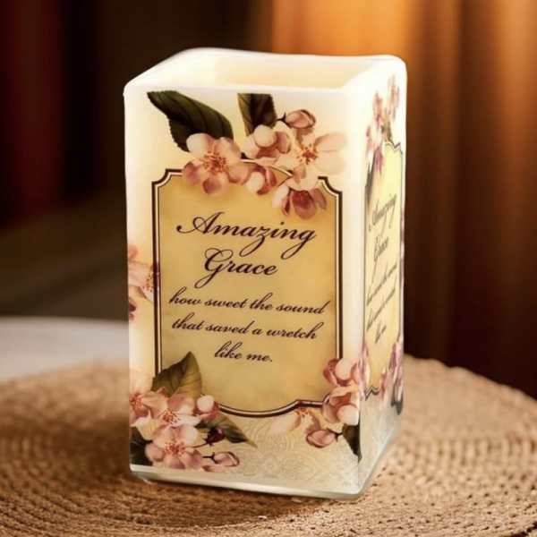 Decorative candle with floral print and the words Amazing Grace