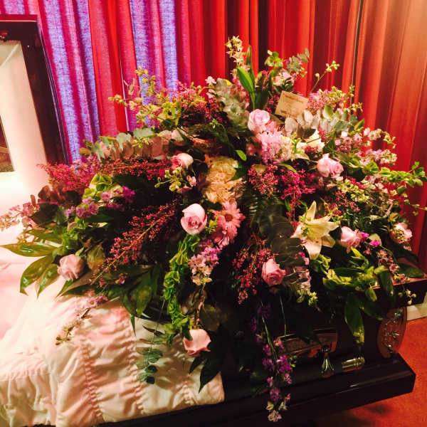 Large floral spray on a casket with pink and white flowers