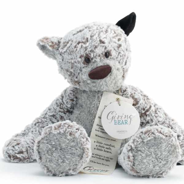 Plush teddy bear with a tag on a white background
