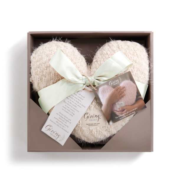 Heart-shaped knitted gift in a box with ribbon and tags