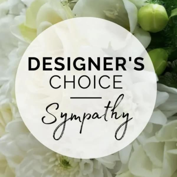 White floral sympathy arrangement with a designer's choice label