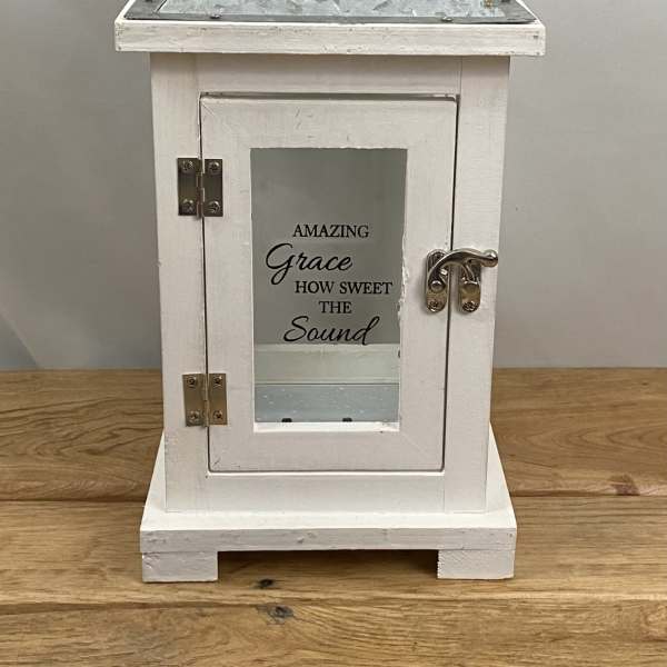 White decorative lantern with a metal handle and glass door