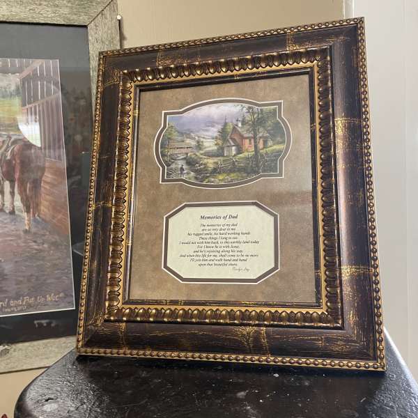 Framed memorial print with a countryside scene and poem
