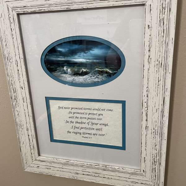 Framed wall art with a stormy ocean scene and a Bible verse