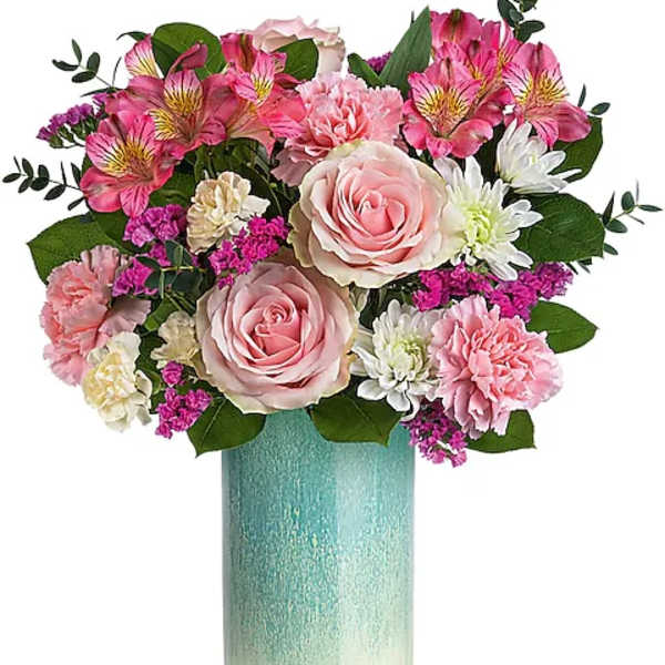 Pink and white flower arrangement in a tall turquoise vase