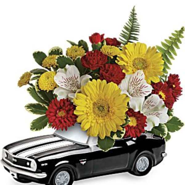 Flower arrangement in a black toy car container