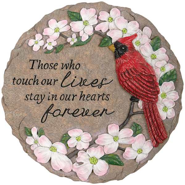 Round memorial plaque with pink flowers and a red cardinal