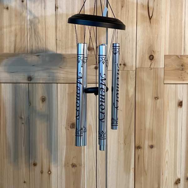Silver memorial wind chime with engraved tubes and a hanging plaque