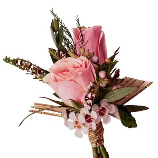 Pink rose boutonniere with small accent flowers and greenery