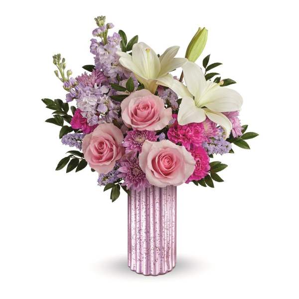 Pink roses and white lilies in a pink glass vase