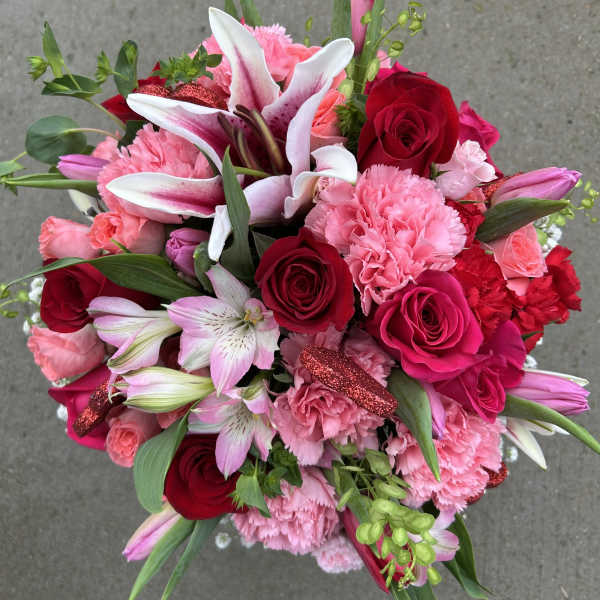 Bouquet of pink and red roses, lilies, and carnations
