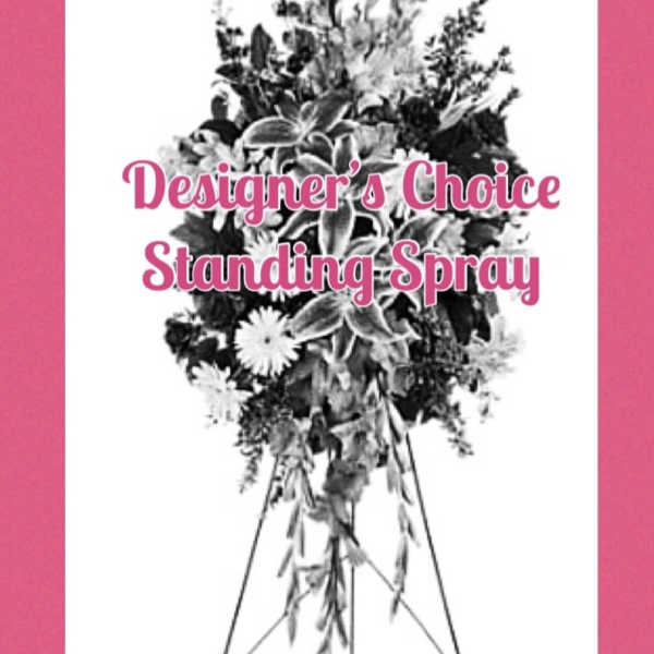 Standing spray on an easel with mixed flowers and greenery