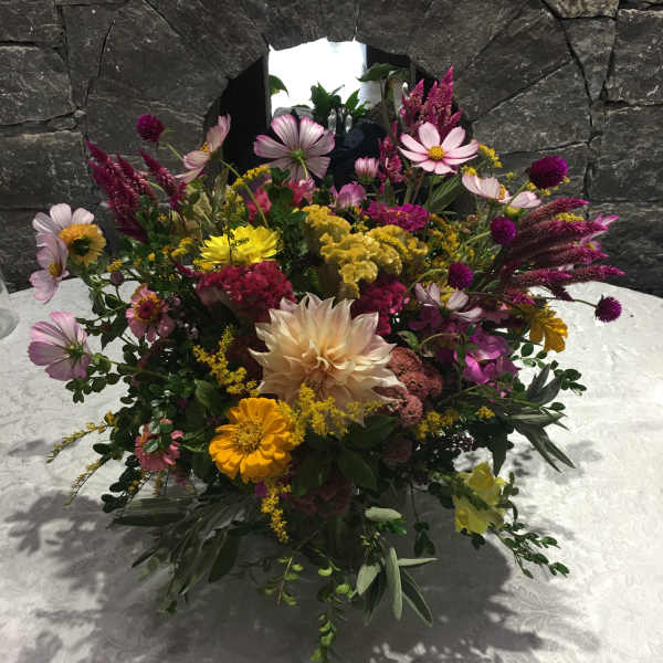 Mixed bouquet with pink, yellow, and cream flowers on a table