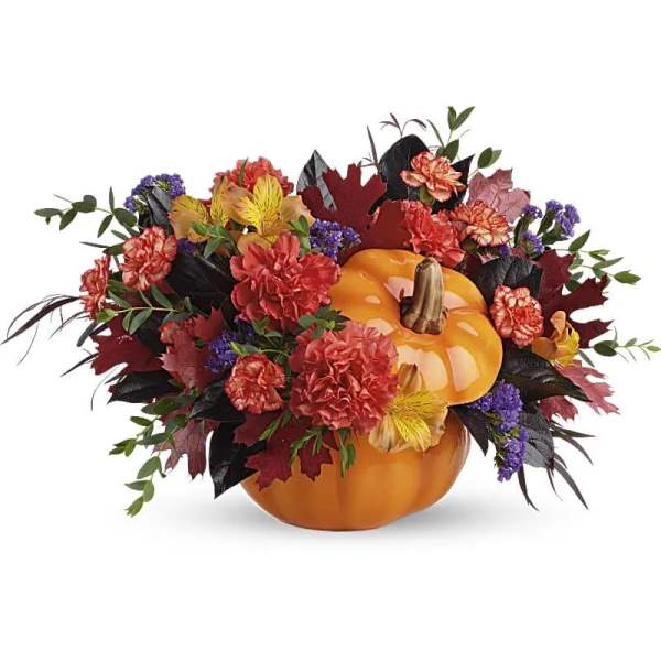 Autumn floral arrangement around stacked pumpkins
