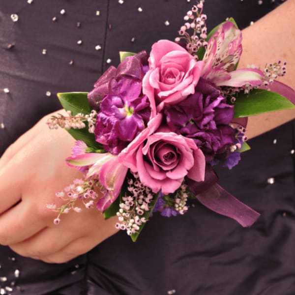 Pink and purple wrist corsage with roses and ribbon